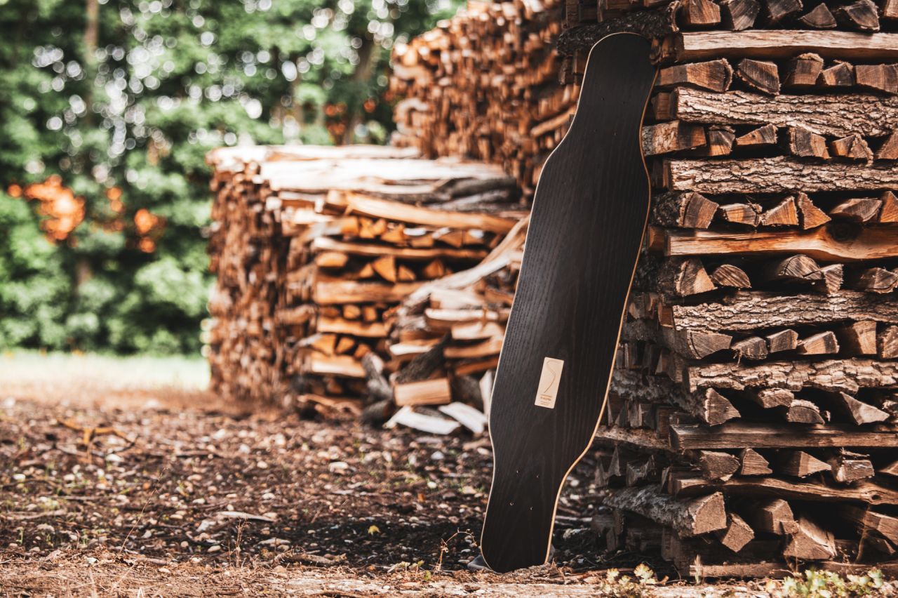 Longboard leaning on some logs